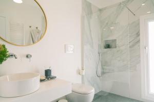 a white bathroom with a sink and a shower at The Vista Rooms & Terrace in Rome +56 photos