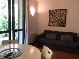a living room with a couch and a table at Apartments in Sirmione/Gardasee 22559 in Sirmione
