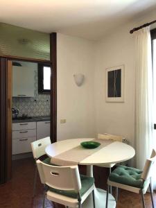 a kitchen with a table and chairs in a room at Apartments in Sirmione/Gardasee 22559 in Sirmione