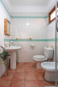 a bathroom with a toilet and a sink at Holiday home in Santa Teresa di Gallura 27331 in Santa Teresa Gallura