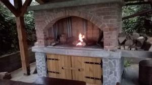 a brick oven with a fire in it at Holiday home in Golik - Gorski Kotar 14249 in Zagolik
