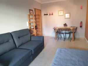 a living room with a couch and a table at Lovely Studio Marta on the beach Falesia, Albufeira in Albufeira