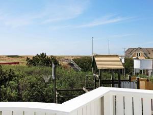 a backyard with a basketball hoop and a white fence at 8 person holiday home in Bl vand in Blåvand