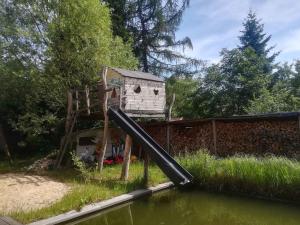 a play house with a slide in the water at Holiday home in Trebbin 2611 in Trebbin