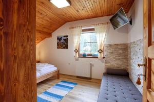 a bedroom with a bed and a tv on a wall at Holiday home in Harrachov 33511 in Harrachov