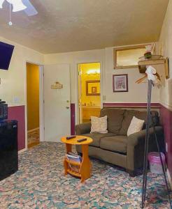 a living room with a couch and a table at Dawson House Lodge in Chemult