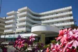 a building with pink flowers in front of it at Waldorf Palace Hotel in Cattolica