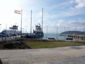 a couple of boats docked at a dock with a flag at Apartments in Szantod/Balaton 35823 in Szántód