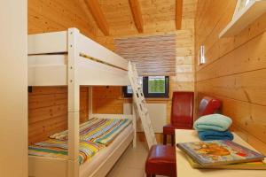 a bunk bed in a cabin with a desk and a chair at Holiday home in Zempin (Seebad) 3240 in Zempin