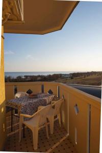 un patio con tavolo e sedie sul balcone. di Apartment in Porto Santa Margherita 25673 a Porto Santa Margherita di Caorle