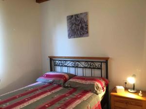 a bedroom with a bed and a table with a lamp at Apartments in Klimno/Insel Krk 12514 in Klimno