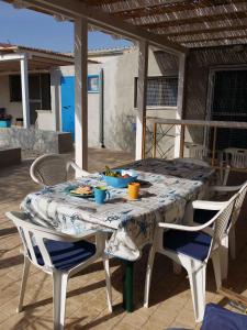 a table and chairs on a patio with food on it at Holiday home in Portopalo 35405 in Portopalo