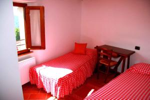 a small room with two beds and a table at Holiday home in Montieri/Toskana 34273 in Montieri