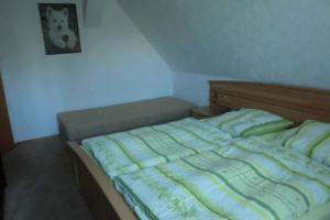 ein Bett in einem Schlafzimmer mit einem Bild an der Wand in der Unterkunft Apartment in Ribnitz-Damgarten 35179 in Ribnitz-Damgarten