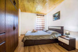 a bedroom with a bed and a wooden ceiling at Holiday home in Krsan 34373 in Kršan
