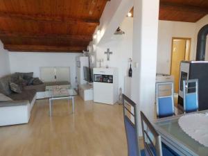 a large living room with a cross on the wall at Apartment in Lovran 34848 in Lovran +13 photos