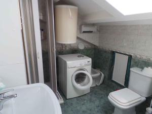 a bathroom with a washing machine and a toilet at Apartment in Lovran 34848 in Lovran