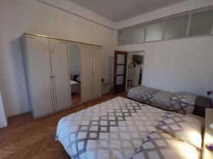 a bedroom with two beds and a mirror at Apartment in Crikvenica 27813 in Dramalj