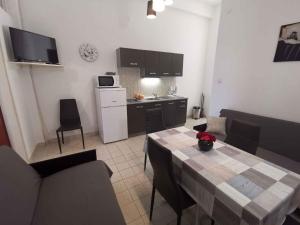 a living room with a table and a kitchen at Apartment in Crikvenica 27813 in Dramalj