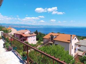 a view of a town from the balcony of a house at Apartment in Lovran 34848 in Lovran