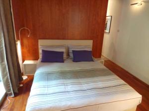 a large bed with blue pillows in a bedroom at Apartments in Rovinj/Istrien 34602 in Rovinj