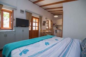 a bedroom with a bed with a blue and white blanket at Apartments in Veli Losinj 33624 in Veli Lošinj