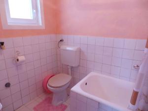 a bathroom with a toilet and a bath tub at Apartment Karlobag/Velebit Riviera 27804 in Karlobag