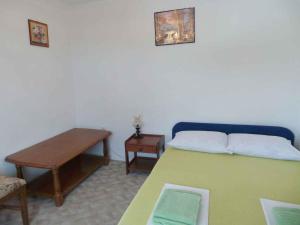 a room with a bed with a table and a tableasteryasteryasteryasteryastery at Apartment Karlobag/Velebit Riviera 27804 in Karlobag