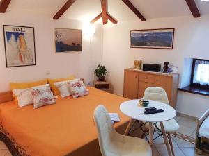 a bedroom with a bed and a table and a tv at Holiday home in Medulin/Istrien 27402 in Medulin