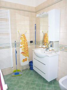 a bathroom with a sink and a mirror and a tub at Apartments in Comano 24163 in Comano Terme