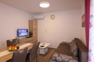 a living room with a table and a dining room at Apartments in Silo/Insel Krk 26753 in Šilo