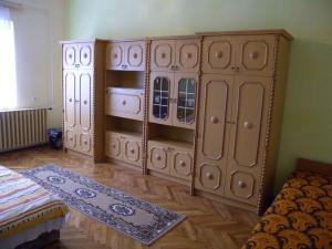 a bedroom with wooden cabinets and a bed at Holiday home in Balatonfenyves 18432 in Balatonfenyves