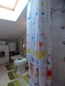 a bathroom with a toilet and a shower curtain at Apartment Volosko 15685 in Volosko