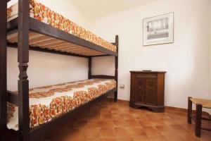 トッレ・デッレ・ステッレにあるHoliday home in Torre Delle Stelle 27350のベッドルーム1室(二段ベッド2組、テーブル付)