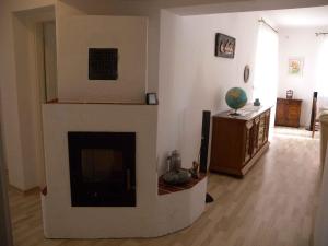 a living room with a fireplace and a television at Holiday home in Balatonszentgyörgy 20188 in Balatonszentgyörgy