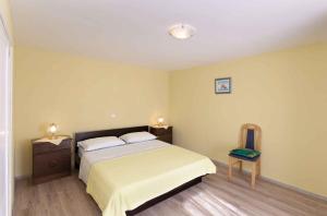 a bedroom with a large bed and two night stands at Holiday home in Lopar/Insel Rab 17776 in Lopar