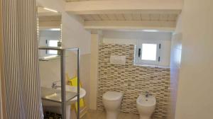 a bathroom with a toilet and a sink at Apartment in Lido Sant´Angelo 21008 in Torre Pinta
