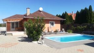 a cat statue standing next to a swimming pool at Holiday home in Balatonszentgyörgy 20188 in Balatonszentgyörgy