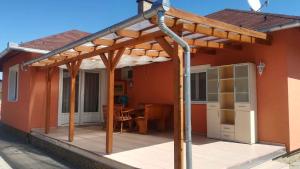 a wooden pergola on a patio of a house at Holiday home in Balatonszentgyörgy 20188 in Balatonszentgyörgy