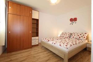 a bedroom with a bed and a wooden cabinet at Apartment in Silo/Insel Krk 13587 in Šilo