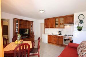 a kitchen with a table and a dining room at Apartment in Silo/Insel Krk 13587 in Šilo
