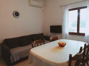 a living room with a table and a couch at Apartment in Maslenica 6886 in Maslenica