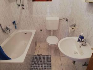 a bathroom with a tub and a toilet and a sink at Apartment in Maslenica 6886 in Maslenica