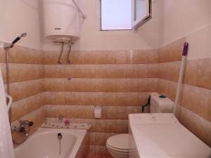 a bathroom with a tub and a toilet and a sink at Apartment in Labin/Istrien 8875 in Raša