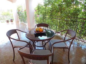 a table and chairs with a bowl of fruit on it at Apartment in Labin/Istrien 8875 in Raša