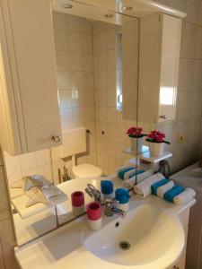 a bathroom with a sink and a large mirror at Apartment in Klimno/Insel Krk 12479 in Klimno