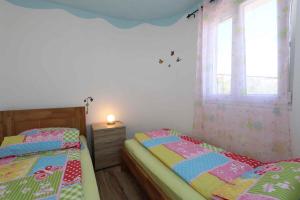 a bedroom with two beds and a window at Apartment in Silo/Insel Krk 13586 in Šilo