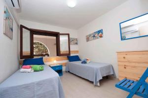 a small room with two beds and a table at Two-Bedroom Apartment in Siracusa I in Ognina