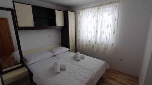 a bedroom with a white bed with two towels on it at Apartment in Malinska/Insel Krk 13118 in Sveti Vid-Miholjice