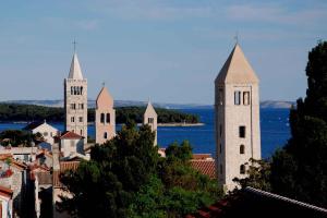 a view of a castle with water in the background at Apartments in Rab/Insel Rab 16117 in Mundanije